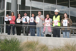 Featured our scholarship recipients holding thank you banner
