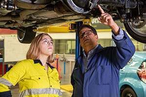 Student guided by our teacher in the automotive workshop.