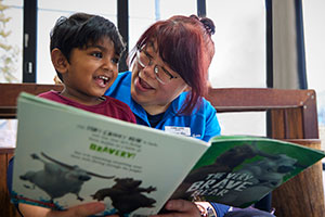 An educator teaching a child in Aurram kids learning centre.
